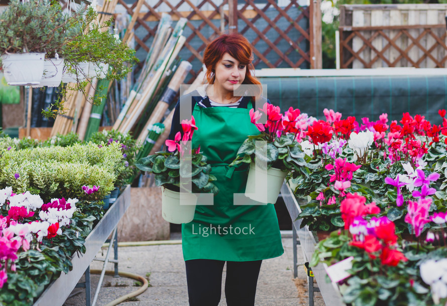 Florist with professional clothing in a plant nursery.  