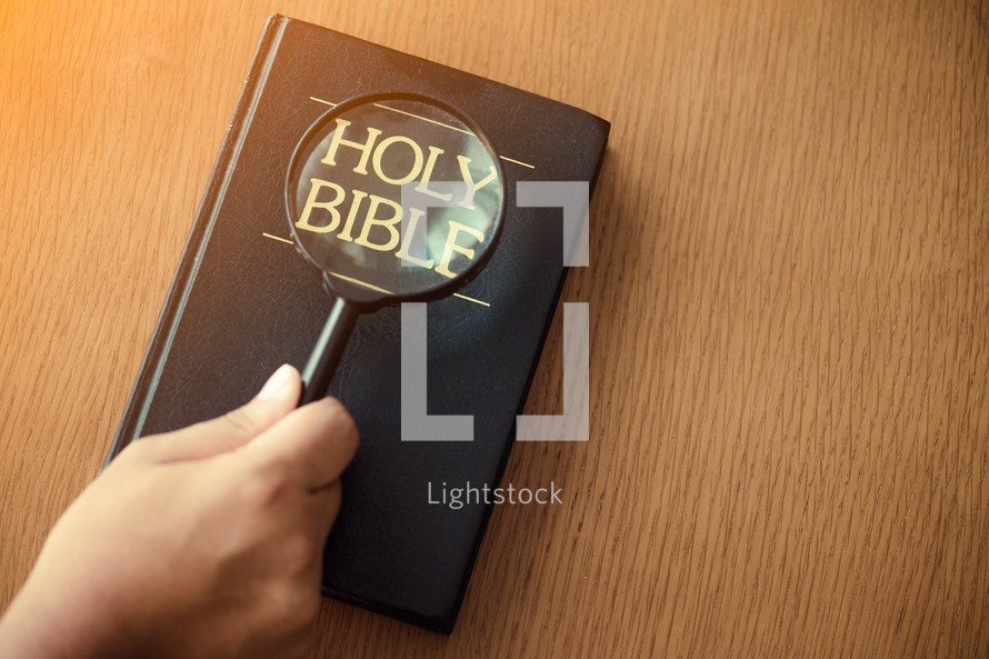 magnifying glass over a Bible 