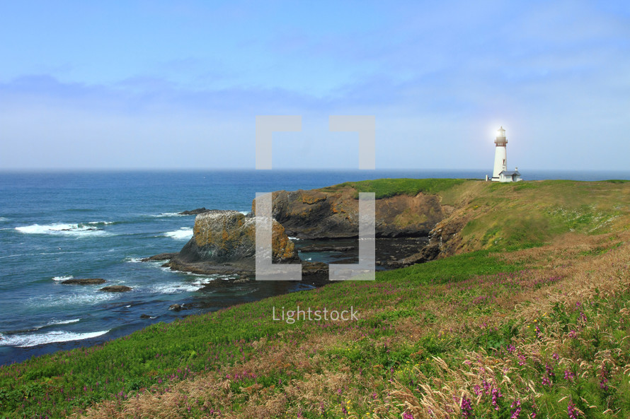 distant lighthouse on a rocky shore