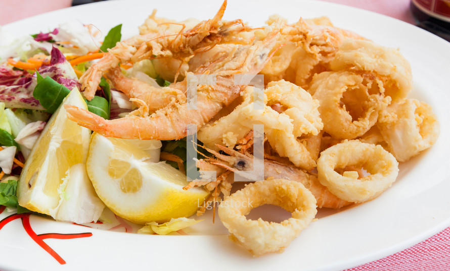 Fried shrimp and squid with lemon, italian food.