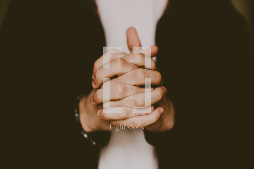 interlaced fingers in praying hands 