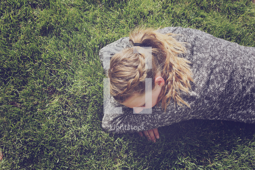 girl lying on grass