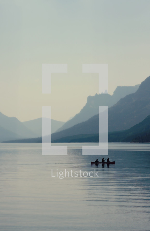silhouette of a canoe on a lake 