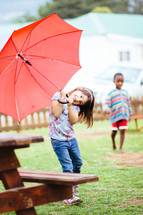 girl child with a red umbrella 