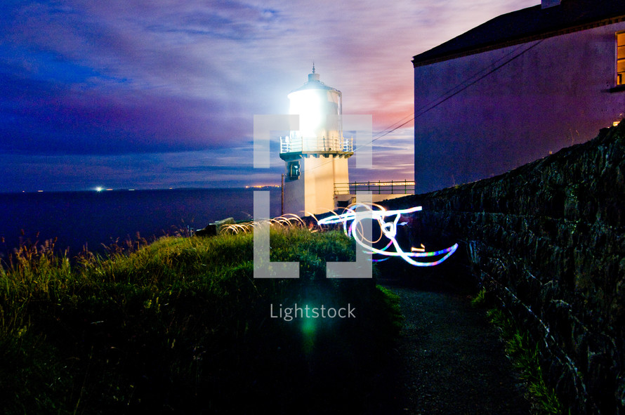 lighthouse beacon light on a coastal evening 