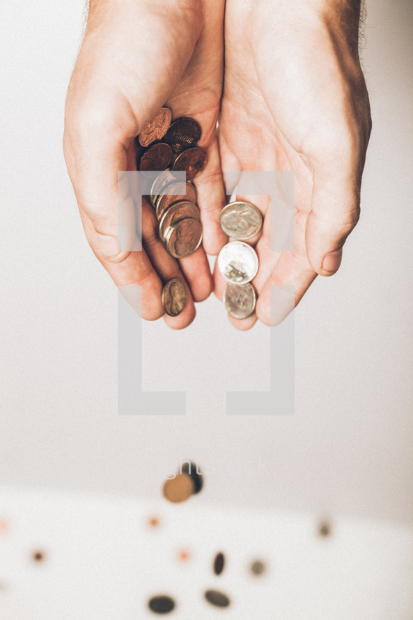 cupped hands pouring out coins