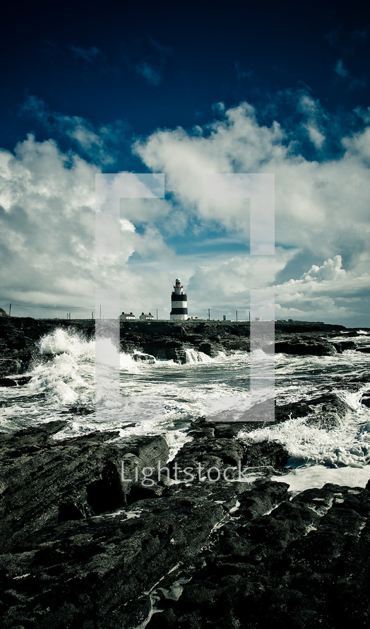 lighthouse and waves along a coast 
