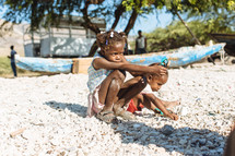 children sitting on a beach in Haiti