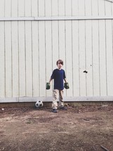 boy child with Hulk gloves and a soccer ball