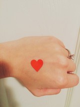 heart sticker on a hand 