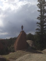 man standing on a rock formation