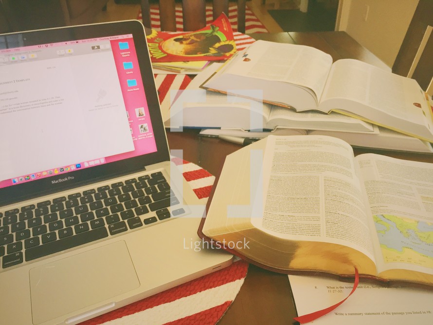 laptop, open Bibles, and journals on a table at a Bible study 