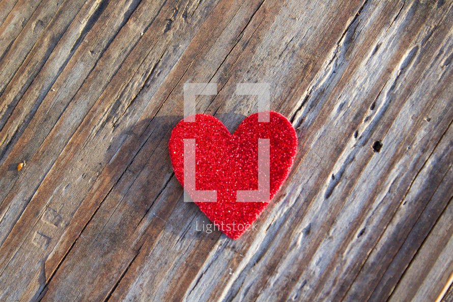 A single heart on a rugged board.