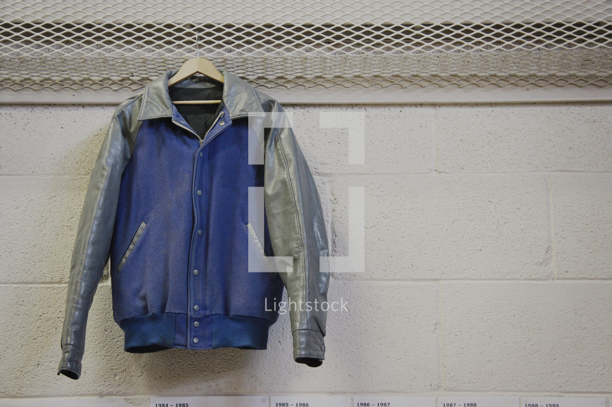 letterman jacket hanging in a locker room 