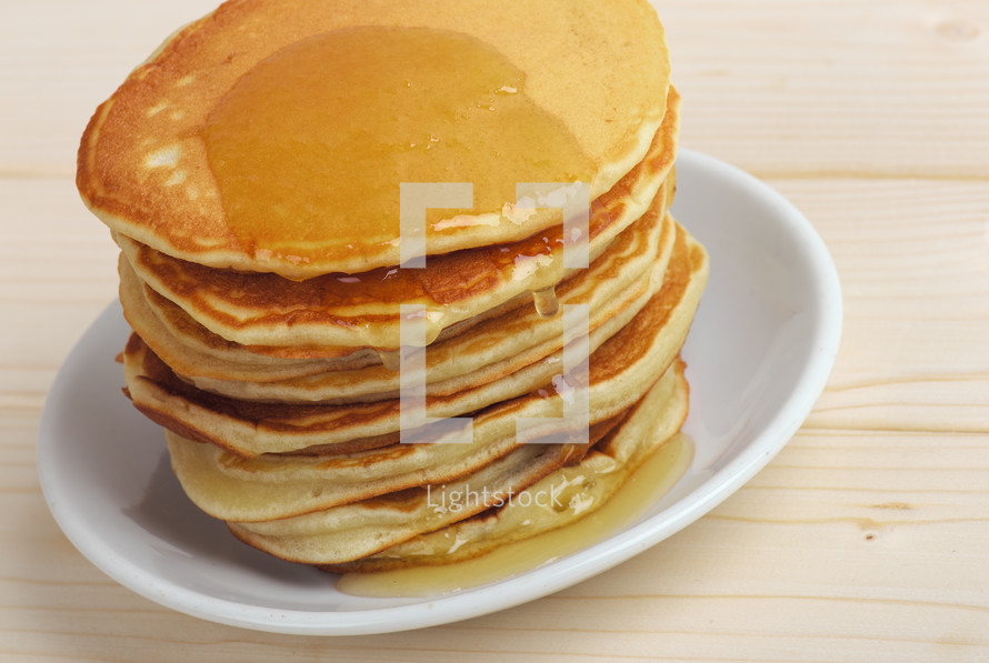stack of pancakes with honey 