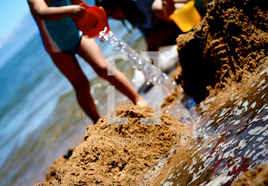 children building sand castles 