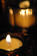 lighted candles in glass holders