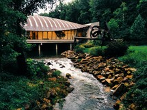 building with unique architecture and a stream 