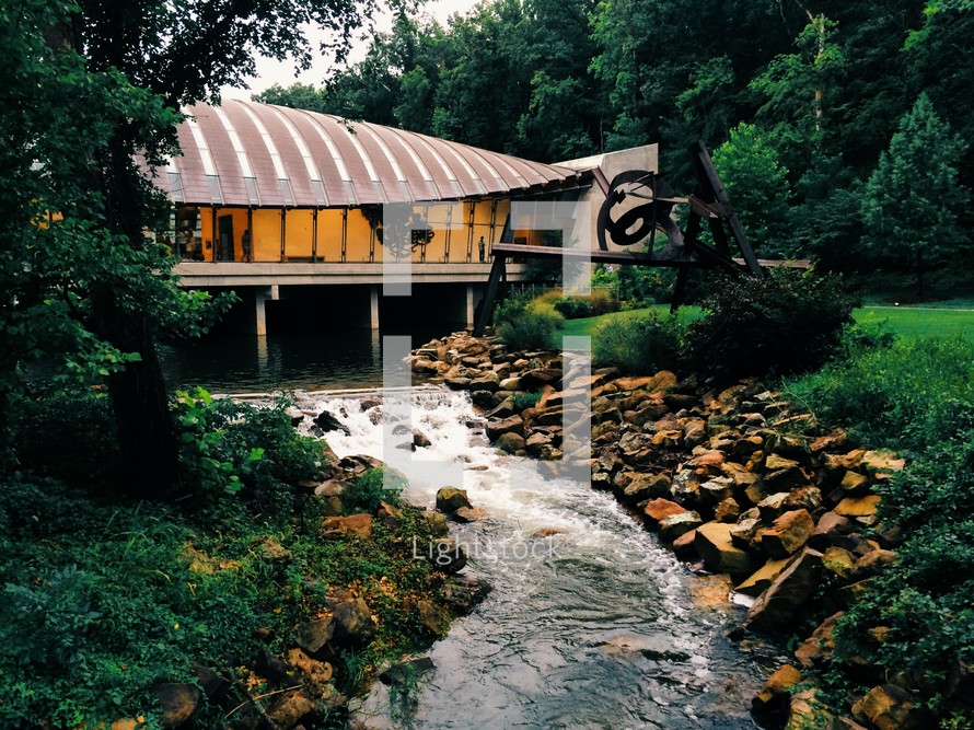 building with unique architecture and a stream 