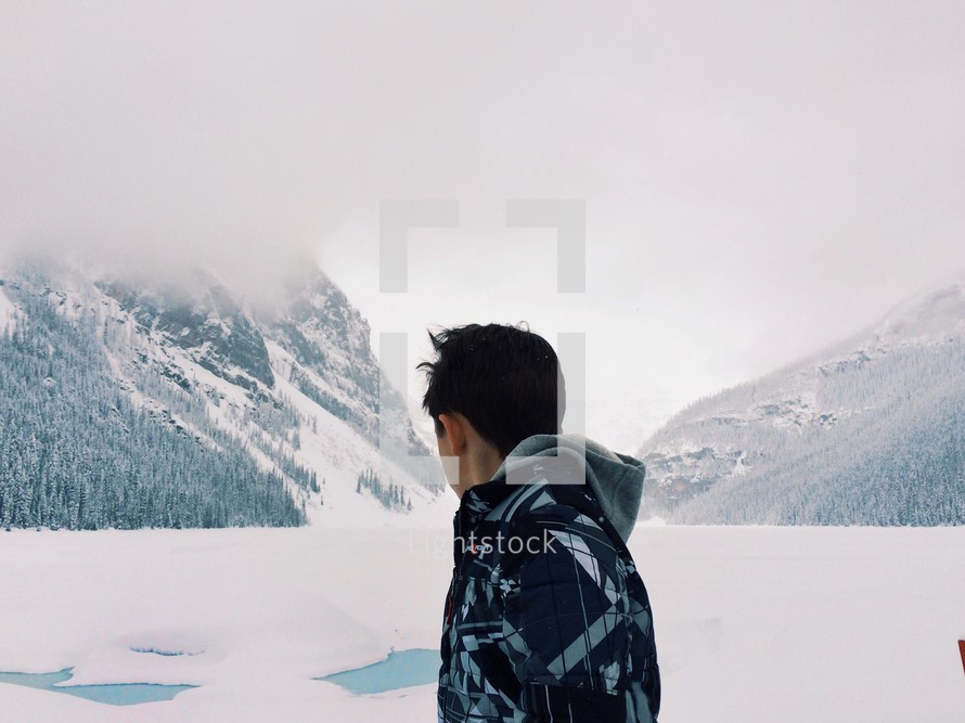 Man looking at the snow-covered mountains.