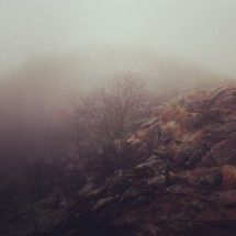 rocky fog covered hillside 