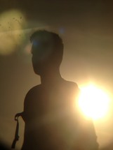 silhouette of a man and intense sun flare