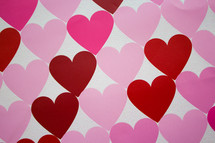 Rows of hearts in shades of pink and red.