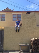 man sitting on a ledge