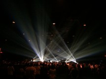 spotlight on stage and an audience at a concert 