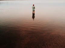 man standing in lake water 