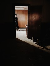 man walking through a doorway
