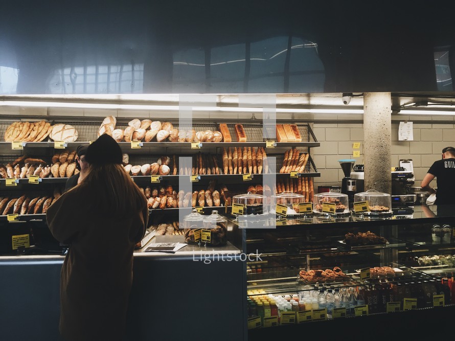 a woman shopping at a bakery 