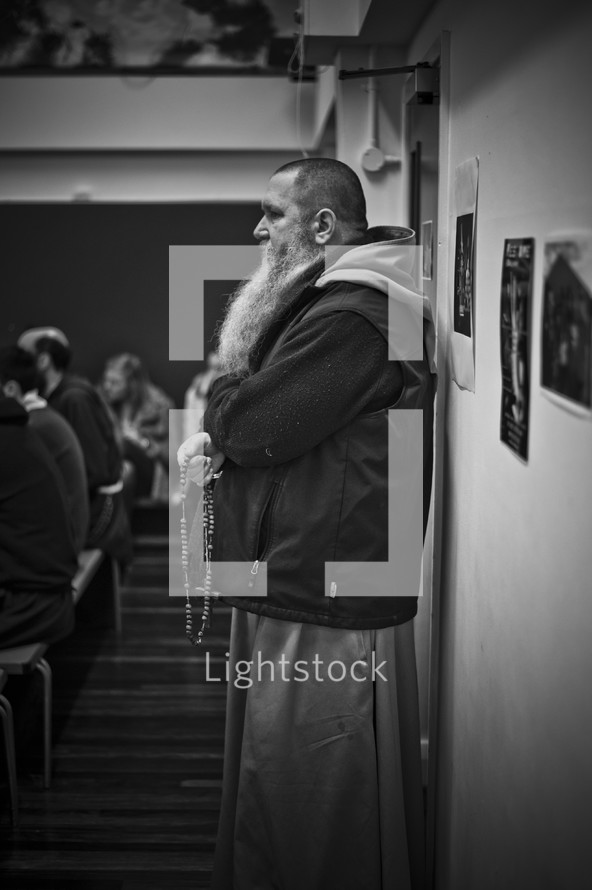Franciscan brother holding a rosary prayer beads