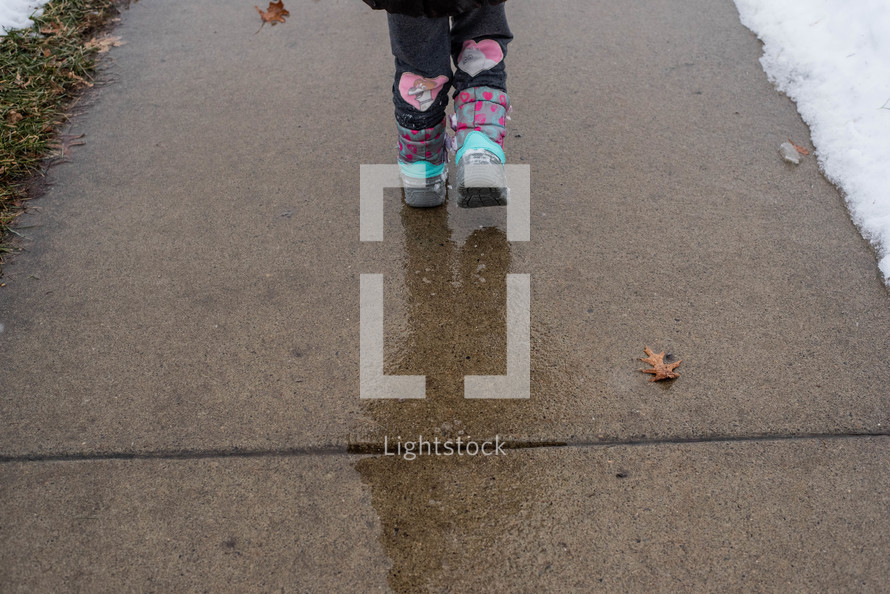 boots on a wet sidewalk 