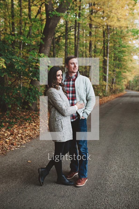 a couple standing on a rural road 
