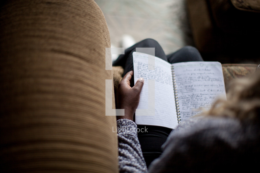 a woman reading from a journal at a Bible study 