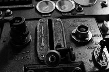 b&w shot of old machinery controls