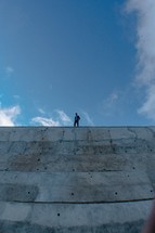 man on top of a steep wall 