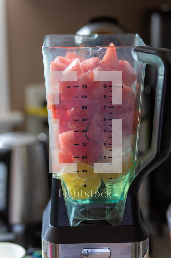 blender filled with lemons and watermelon