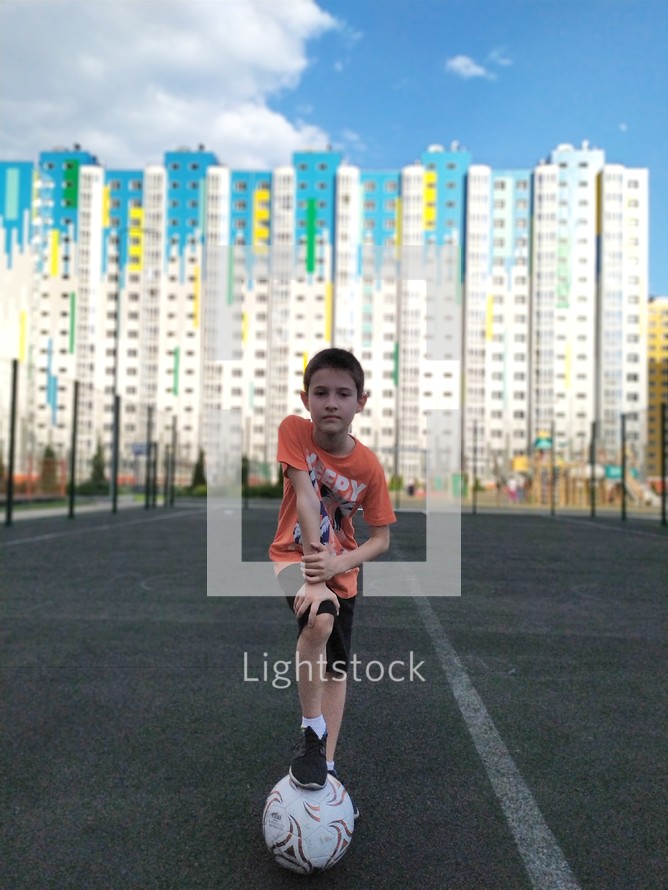 a child on a playgrond with a soccer ball 