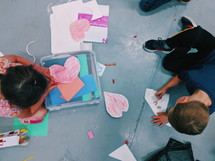 children coloring and cutting paper 