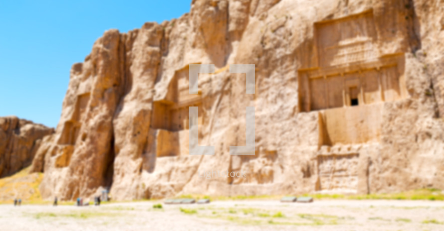 blurry image of buildings carved into rock 