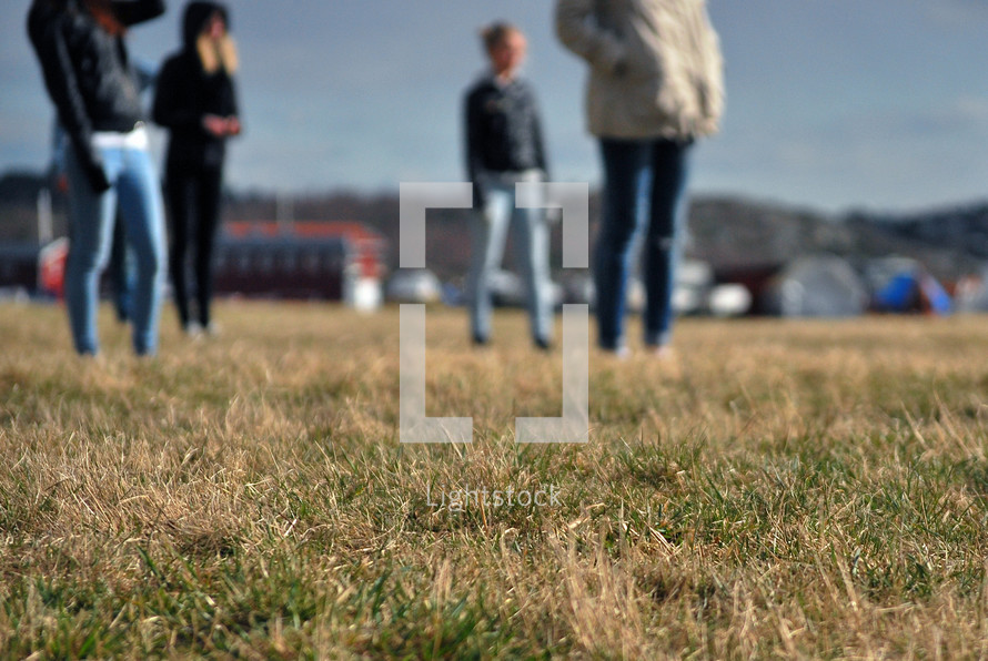 people standing in grass