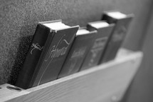 hymnals in the back of a pew 