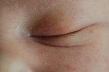 closed eyelid of a sleeping baby 