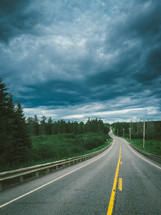 gray clouds over a rural highway 