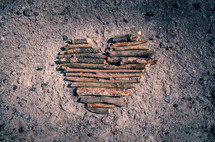 heart made with sticks in ashes