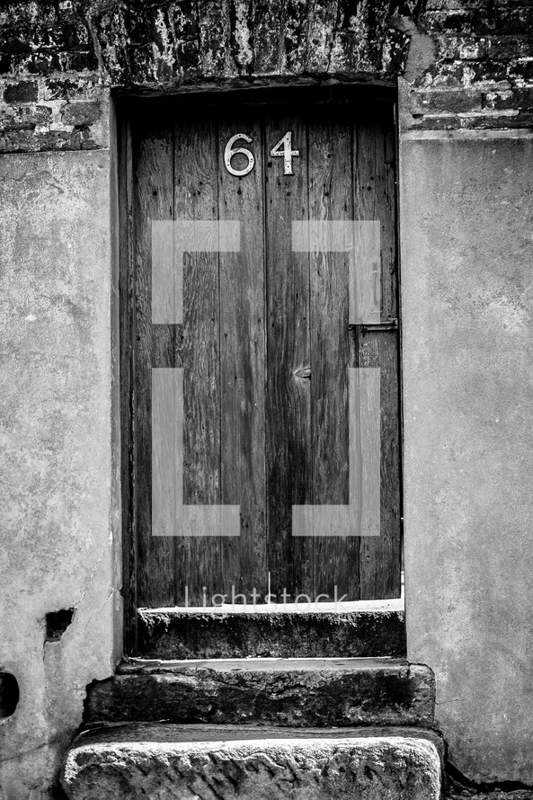 address 64 on an old wood door 