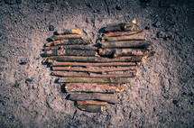 heart shape made in ashes out of sticks