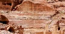 homes carved into red rock cliffs 